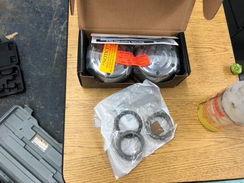 1995 Ford Bronco - New wheel hub assemblies and bearings are laid out on a table, ready for installation.