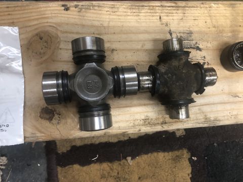 1995 Ford Bronco - A new universal joint is shown next to a used one, likely for a "Brakes Job" as indicated by the registry.