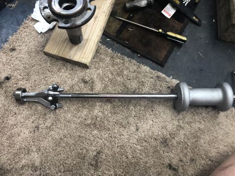 1995 Ford Bronco - Tools for automotive repair, including a slide hammer and bearing puller, alongside a wheel hub.