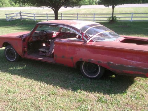 1960 Ford Starliner - This vintage coupe, likely a 1959 model, is in a state of disrepair and appears to be a project car.