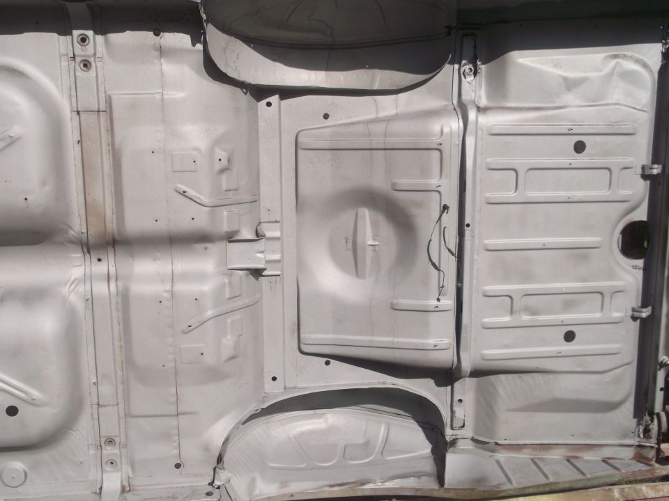 underbody of a vehicle, showing frame rails and floor pan