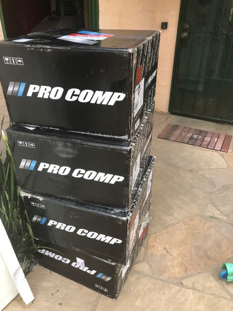 1992 Jeep Wrangler - Boxes of Pro Comp parts stacked on a patio.