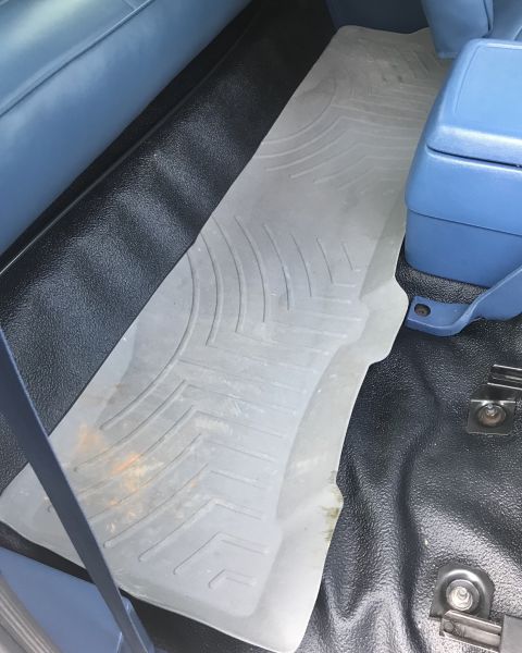 1995 Ford Bronco - Interior view of a vehicle's floor mats and center console.