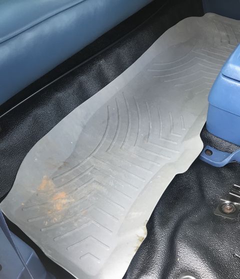 1995 Ford Bronco - Close-up of a vehicle's interior showing a floor mat and part of the seat.