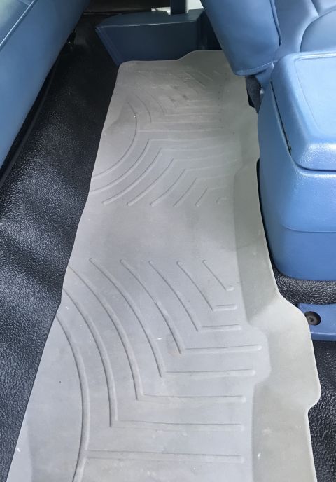 1995 Ford Bronco - Close-up of the interior floor mats in a vehicle, showing their textured design and coverage.