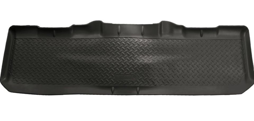 Black rubber floor mat with diamond plate texture and raised edges