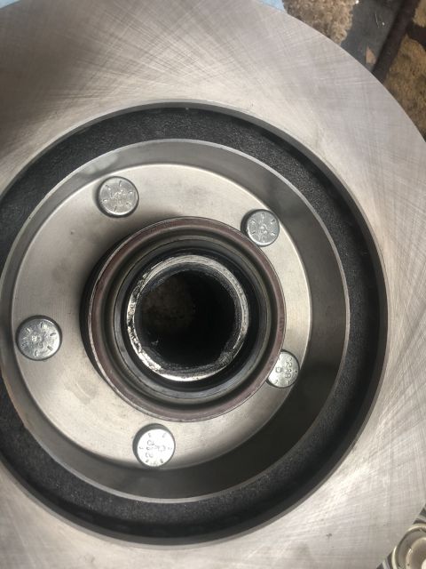 1995 Ford Bronco - Close-up view of a vehicle's brake rotor and hub assembly, showing lug bolts.