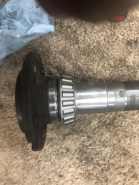 1995 Ford Bronco - Close-up of a wheel bearing and axle shaft, likely for a vehicle repair or maintenance project.