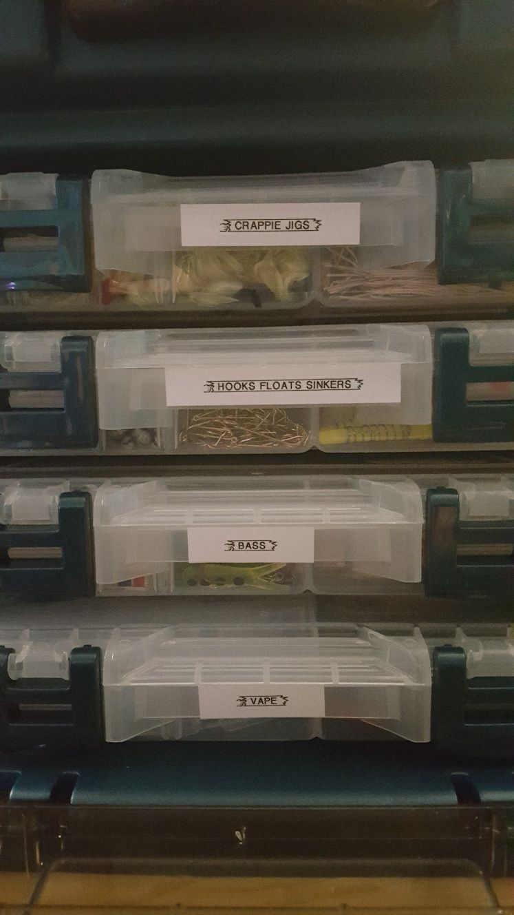 Fishing tackle boxes labeled 'CRAPPIE JIGS', 'HOOKS FLOATS SINKERS', 'BASS', and 'SWAPES'