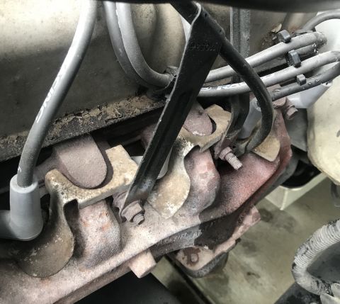 1995 Ford Bronco - Engine exhaust manifold and spark plug wires are visible in this close-up shot.