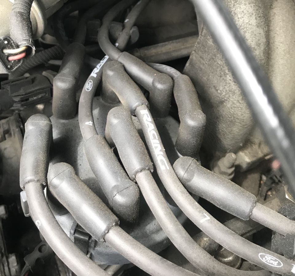 Engine spark plug wires with 'RACING' text visible