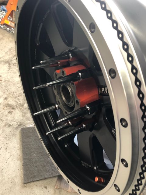 1992 Jeep Wrangler - Close-up of a custom wheel red accents and distinctive spike lug nuts, likely for a performance vehicle.