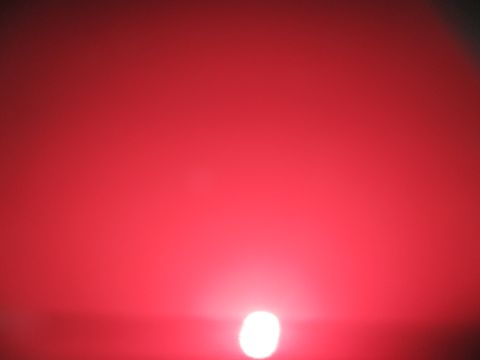 2004 Ford Crown Victoria - A bright red light is visible against a dark red background, with a website logo in the corner.