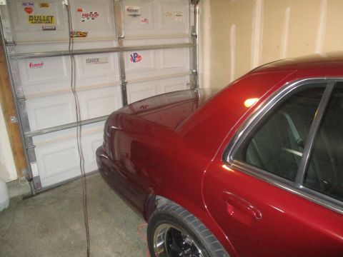 2004 Ford Crown Victoria - Rear view of a red 2004 Ford Crown Victoria parked in a garage.