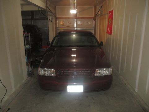 2004 Ford Crown Victoria - Maroon 2004 Ford Crown Victoria parked head-on in a garage.