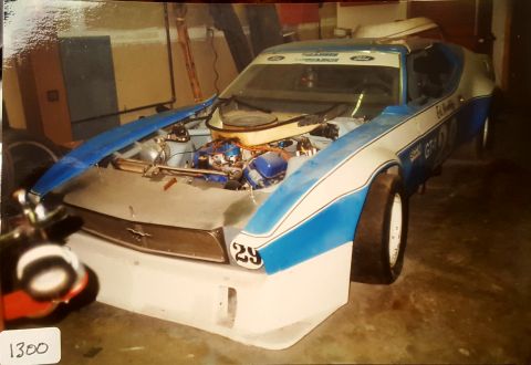 1973 Ford Mustang - This 1973 Ford Mustang race car is displayed with its hood open, revealing the engine and racing decals.