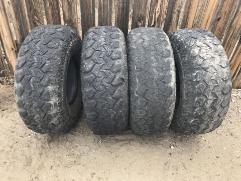 1984 Ford Bronco - Set of four off-road tires for sale, ready for adventure.