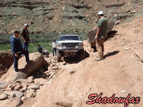 1995 Ford Bronco - 1995 Ford Bronco navigating a rough terrain, possibly off-roading.