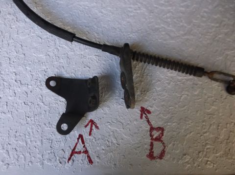 1979 Ford Ranchero - Close-up of a brake cable and a mounting bracket, labeled A and B, against a textured wall.