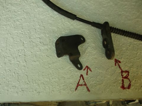 1979 Ford Ranchero - Close-up of unidentified metal brackets and a cable, possibly automotive parts.