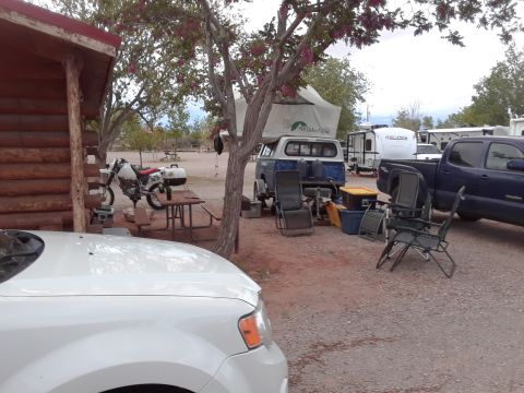 1994 Ford Bronco - A campsite scene with multiple vehicles including a car, camper van, and pickup truck.
