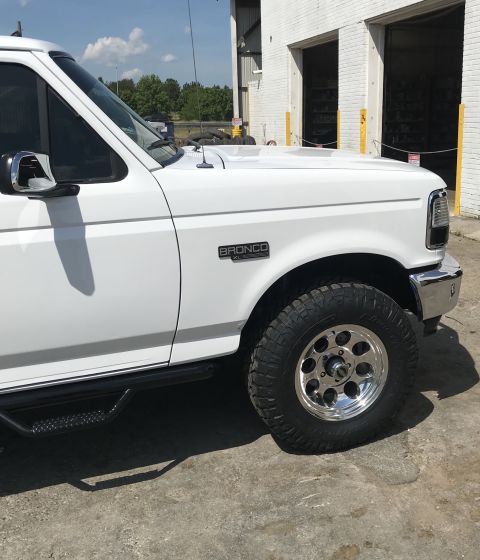 1995 Ford Bronco - This 1995 Ford Bronco is shown from a 3q-front angle, with the 'BRONCO XL' badge clearly visible on the fender.