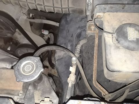 1996 Ford F-350 - Close-up view of engine bay components, including the radiator cap and various hoses.