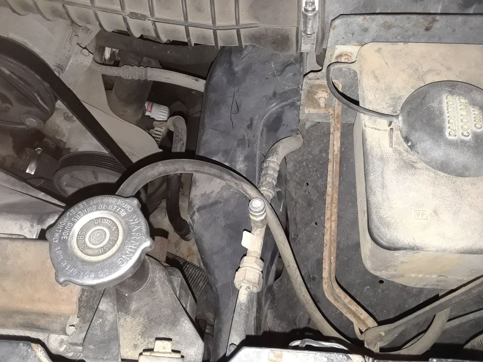 Engine bay with radiator cap and hoses visible