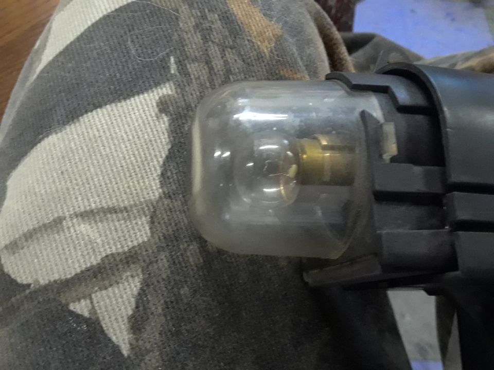 close-up of a clear fuel filter with brass fittings