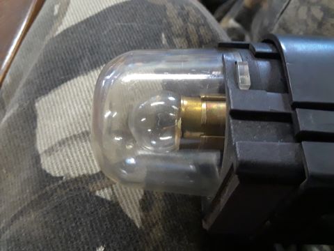 1985 Ford Bronco - Close-up of a vehicle's light bulb socket, showing internal components.