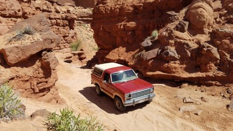 1985 Ford Bronco - 1985 Ford Bronco navigates a rocky canyon trail.