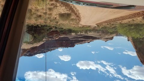 1985 Ford Bronco - A scenic desert view, likely from Moab, Utah, captured through a vehicle's window.