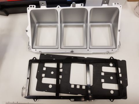 1978 Ford Bronco - Gauge cluster housing and associated trim pieces are laid out on a flat surface.