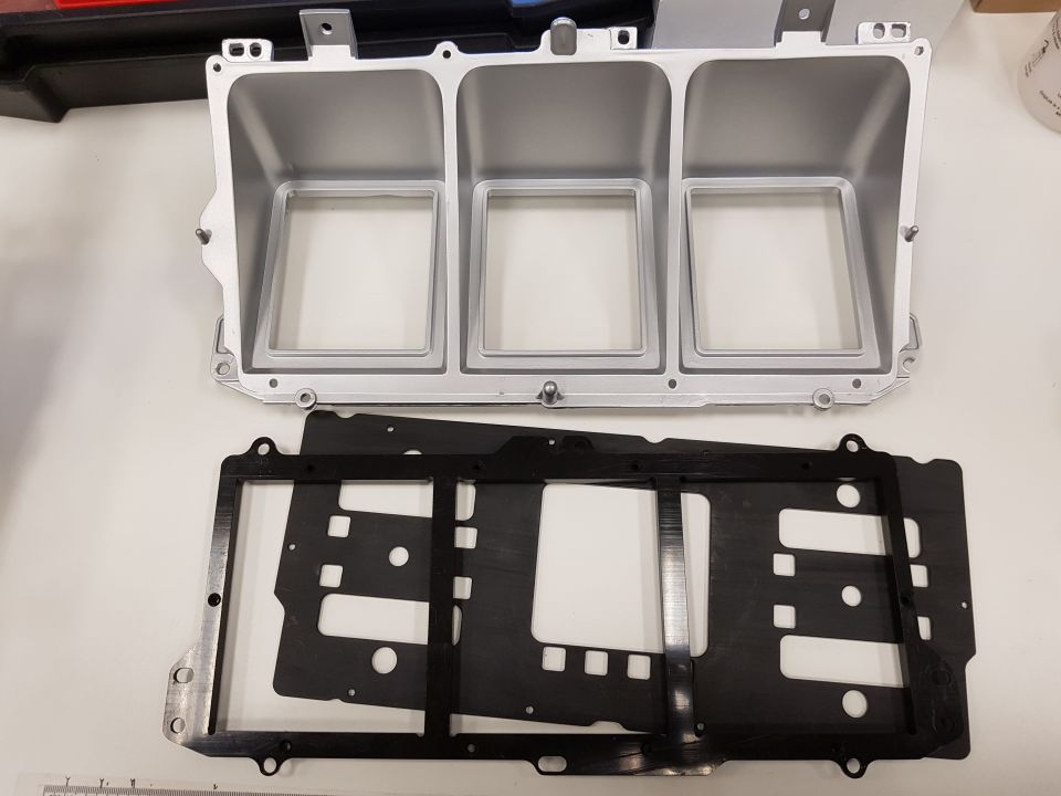 Gauge cluster housing with three openings and black trim pieces