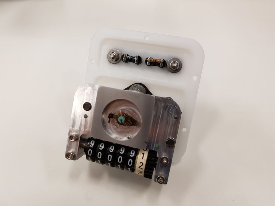 Odometer mechanism with rotating number wheels showing 999999 and 123