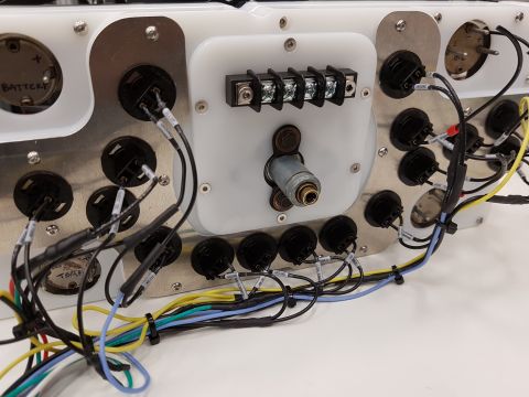 1978 Ford Bronco - A close-up view of a custom-built dashboard wiring harness with numerous electrical connections and gauge ports.