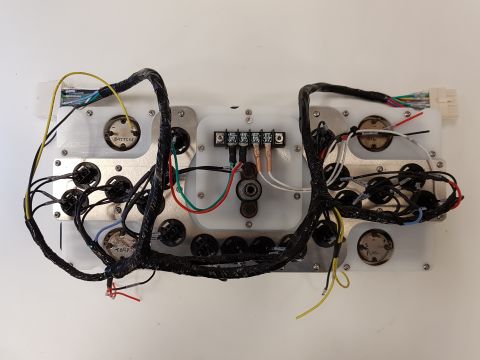 1978 Ford Bronco - A complex vehicle dashboard wiring harness is shown, numerous electrical connections and gauge housings.