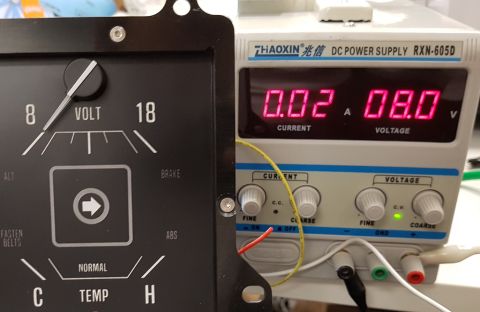 1978 Ford Bronco - A close-up view shows a vintage car's voltage gauge next to a digital DC power supply. The voltage gauge has a needle pointing between 8 an…