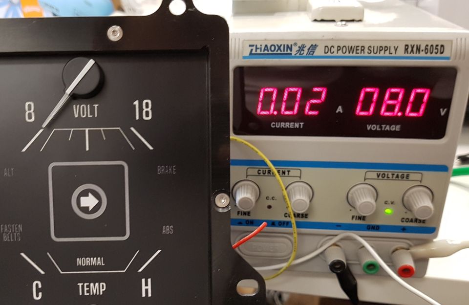 Vintage voltage gauge and a digital DC power supply