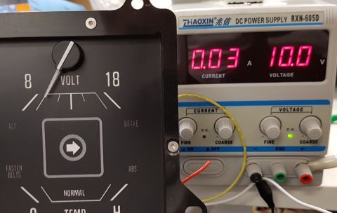 1978 Ford Bronco - A close-up shows a vintage analog voltmeter gauge next to a digital DC power supply displaying 10.0V and 0.03A. The voltmeter has markings…