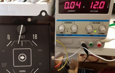 1978 Ford Bronco - A close-up view shows a vintage voltage gauge next to a modern power supply unit. The voltage gauge has a needle pointing to approximately…
