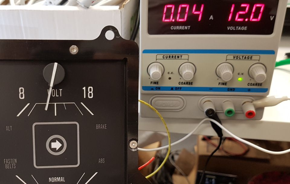 Vintage voltage gauge and modern power supply unit