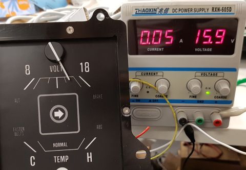 1978 Ford Bronco - A close-up view of a vintage analog gauge and a digital DC power supply. The gauge appears to be for a vehicle, possibly indicating voltage…