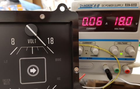 1978 Ford Bronco - A close-up of a vintage-style analog voltmeter next to a digital DC power supply. The voltmeter shows a reading of 18 volts, matching the p…