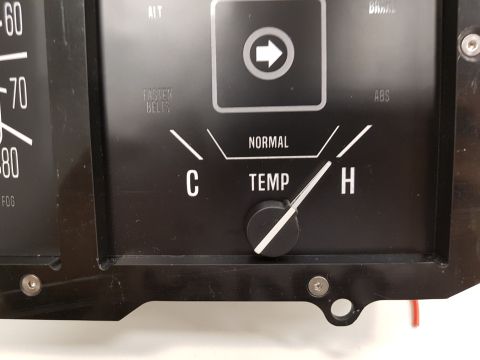 1978 Ford Bronco - A close-up view of a vintage vehicle's instrument cluster shows a temperature gauge with markings for 'C', 'NORMAL', and 'H', along with ot…