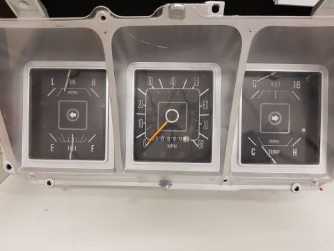 1978 Ford Bronco - A close-up view of a vintage Ford Bronco instrument cluster, featuring gauges for oil, fuel, speed, voltage, and temperature. The cluster i…