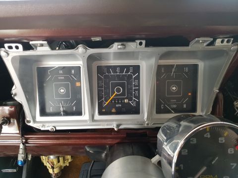1978 Ford Bronco - The interior of a 1978 Ford Bronco displays its functional dashboard gauges, including oil, fuel, and temperature indicators.
