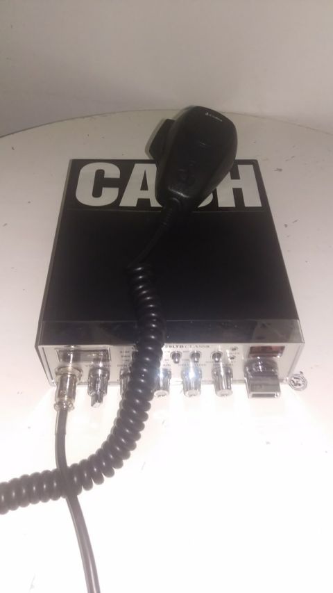 1988 Ford Bronco - A close-up view of a CB radio unit with its microphone and various connection ports visible.