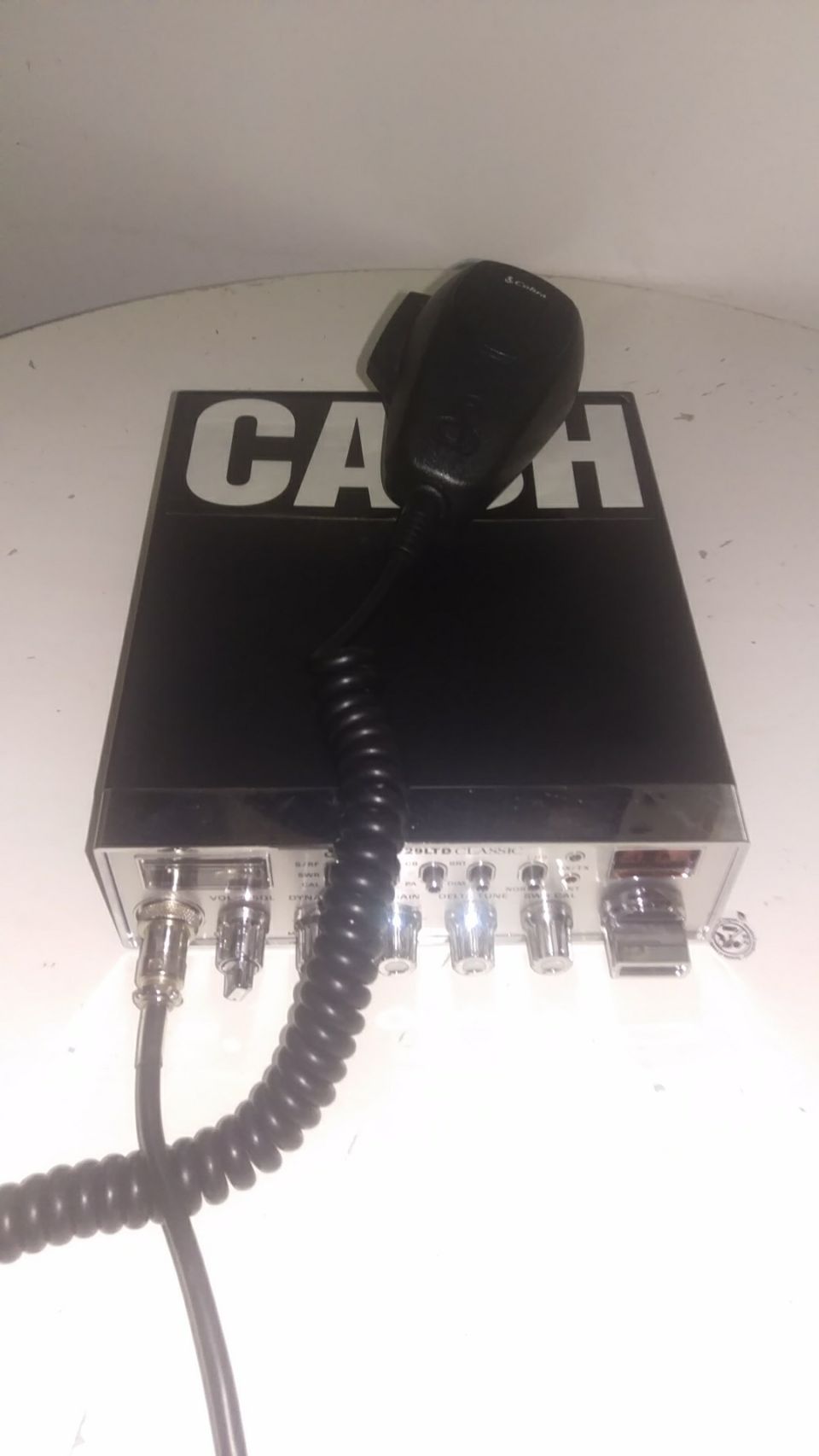 CB radio with microphone attached, "CASH" text on top