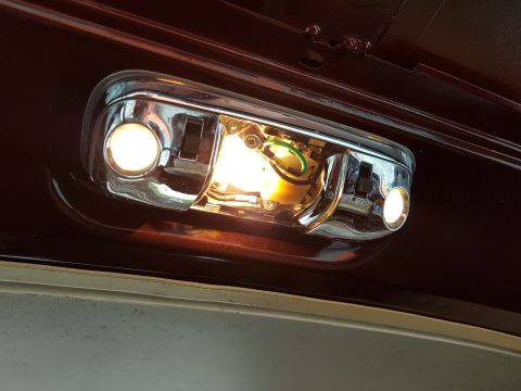 1978 Ford Bronco - The interior dome light assembly shows exposed wiring and chrome accents.